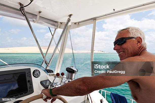 Retired Male At Wheel Of Luxury Yacht Stock Photo - Download Image Now - Benguerra Island, Mozambique, Bazaruto