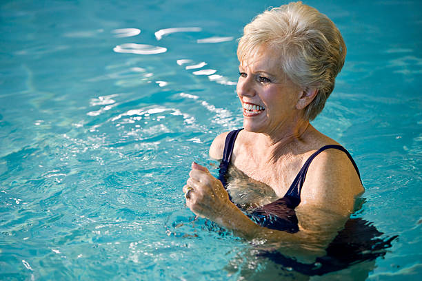 istock Active senior woman in swimming pool 183368362