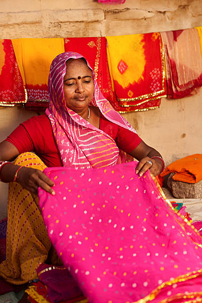 istock Woman selling colorful fabrics 183368431