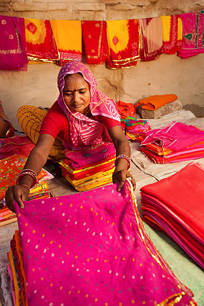 istock Woman selling colorful fabrics 183368434