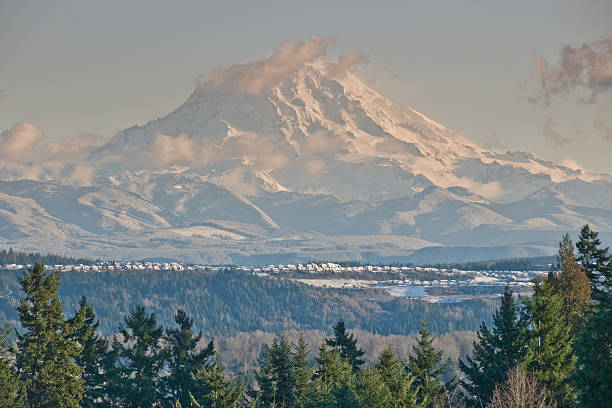 Housing Development Near the Base of Mount Rainier At 14,410' above sea level, Mount Rainier dominates the landscape of the Puget Sound region. Mount Rainier is the highest point in Washington State, and is also the most glaciated mountain in the continental United States. This picture of a housing development near the base of Mount Rainier was taken from Edgewood, Washington State, USA. extinct volcano stock pictures, royalty-free photos & images