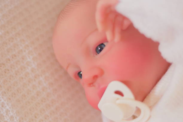 istock Baby (Reborn Doll) with his Hand on his Face 1833693506