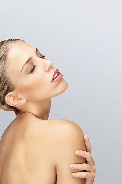 istock Topless young female posing against colored background 183369557