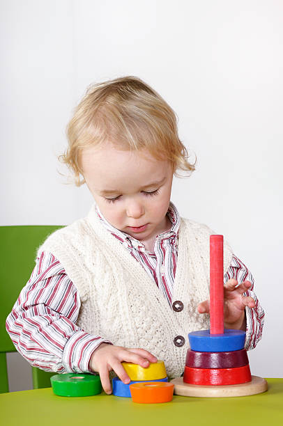 istock Little Boy/ Toddler Playing With Rings In A Nursery Setting 183370041