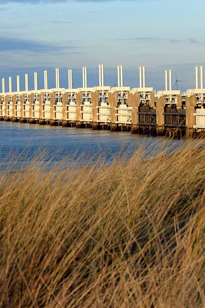 Eastern Scheldt Storm Surge Barrier, in Dutch Oosterscheldekering, between the islands Schouwen-Duiveland and Noord-Beveland, is the largest of the 13 ambitious Delta Works series of dams. They were designed to protect the Netherlands from flooding. The construction of the Delta Works was in response to the North Sea Flood of 1953; Neeltje Jans, Netherlands