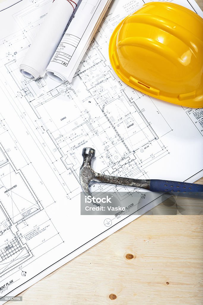 Construction Project "Picture of blueprints, helmet and hammer on plywood." Interior Designer Stock Photo