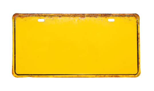 Old rusted yellow license plate