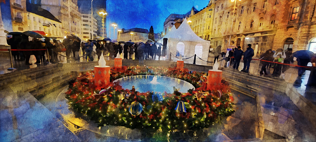 Watercolor effect on a photo of the Advent Wreath around the fountain (Christmas decorated) in Bana Jelačiča Square in Zagreb city centre, in Croatia. People attending the advent / Christmas market, stalls, entertainment tents in the christmas decorated square in the rain and snow in the Advent season celebration. Watercolor effect on a real photo.