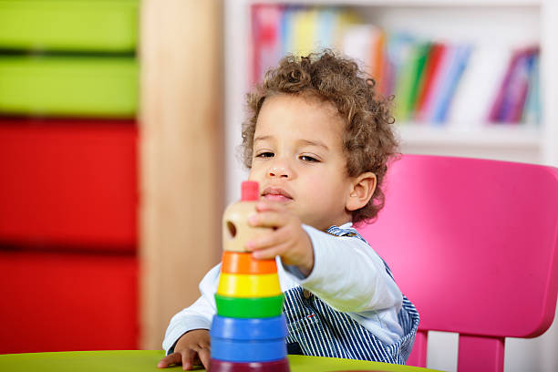 istock Close-up Of Toddler Playing With Multi-Coloured Rings 183372255