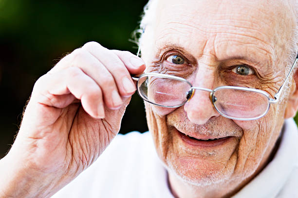 istock Happy old man smiles, looking over his spectacles 183372311