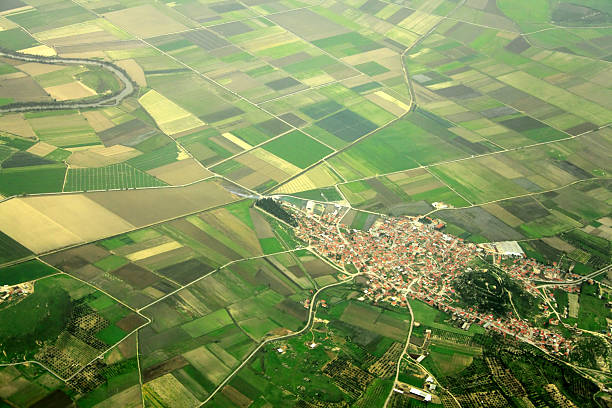 small town elevated view of farm fields and small town in Izmir, Turkey. crop circle stock pictures, royalty-free photos & images