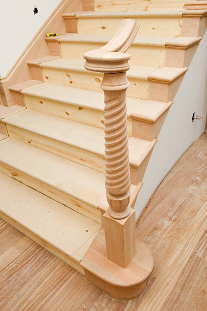 Detail of old-fashioned wooden staircase and cast iron railing. Lugo city, Galicia, Spain. Beautifully carved end of the handrail.