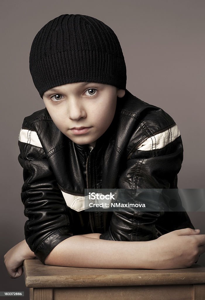 Cute boy. Fashion studio portrait of a little boy in black hat and leather jacket. Young model looking at camera.Similar images: 10-11 Years Stock Photo