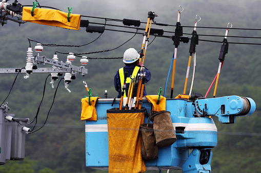 Electrician repairs a power line