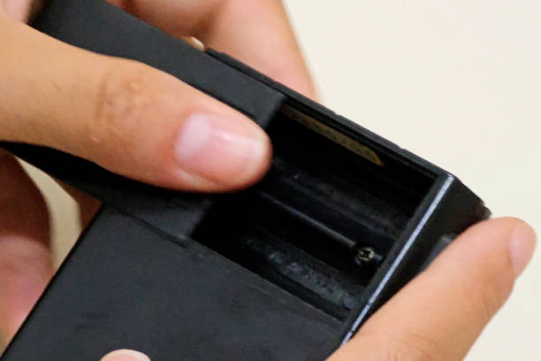 istock Putting batteries in an old calculator 1833752032
