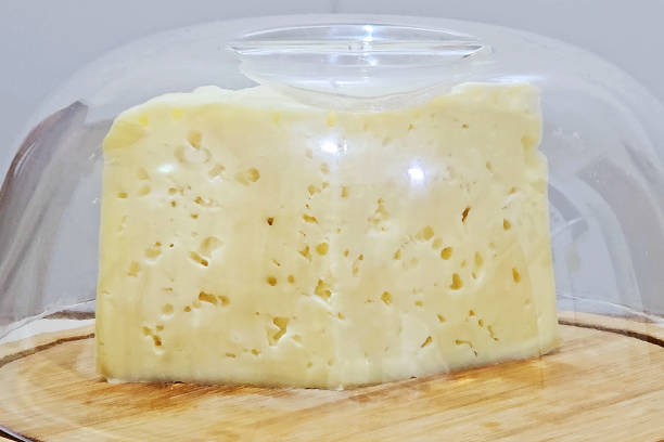 istock White cheese with holes in a cheese holder 1833753121