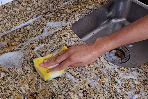 Rubbing the detergent with a sponge