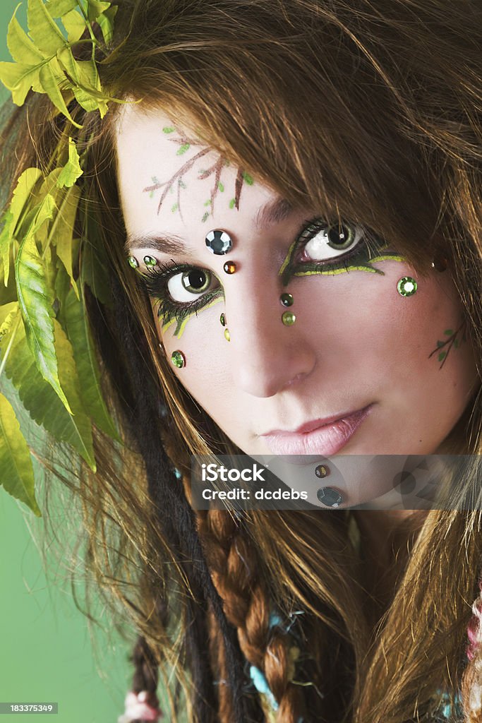 Young Woman With Face Painting A young woman painted with plants and leaves. 18-19 Years Stock Photo