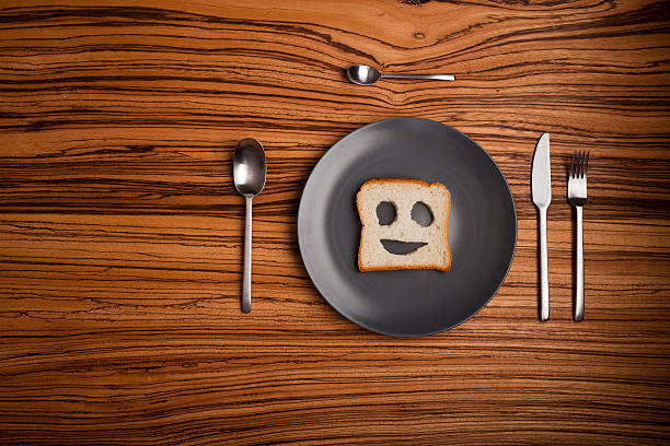 istock Table setup with smile face bread slice instead of food 183375360