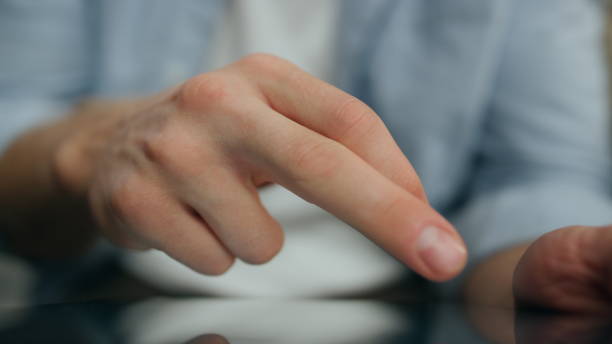 istock Man fingers typing tablet screen indoors close up. Unknown guy texting new tab 1833755878