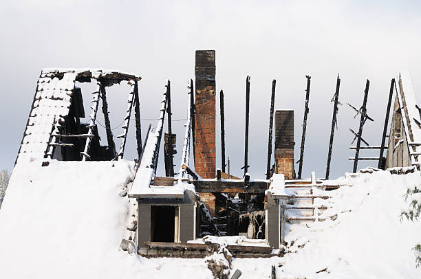 burnt house in winter stock photo