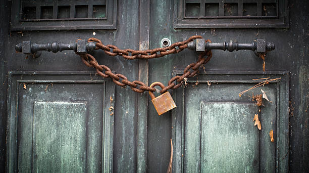 istock Crypt Door Sealed with Rusty Chain and Padlock 183375810