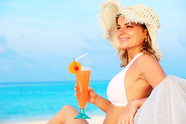 istock Attractive young girl looking at side and drinking a cocktail. 183375967