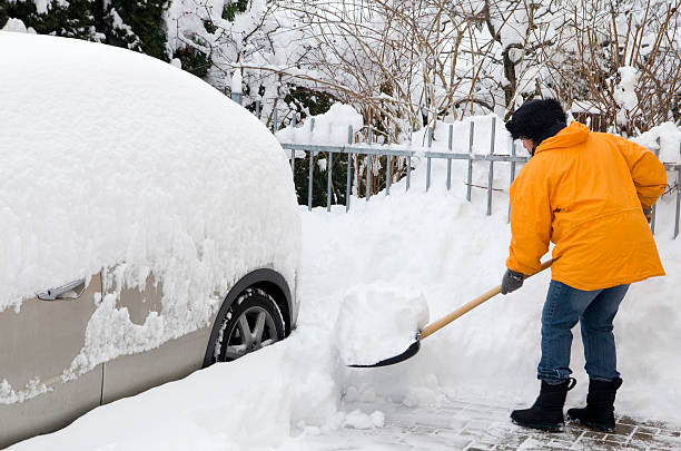 istock Woman shovelling driveway 183376111