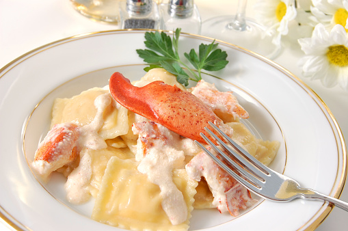 Freshly made lobster ravioli topped with a light cream sauce and a whole lobster claw.