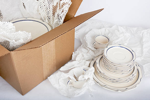 Dishes being Securely Packed Away stock photo