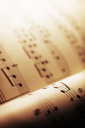Close-up shot of sheet music in sepia tone.