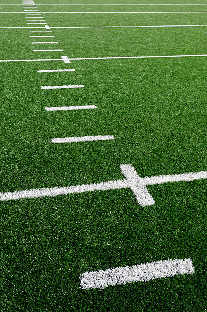 American Football Field Grass Turf Grass on a football sports field with the white hash marks. american football field photos stock pictures, royalty-free photos & images