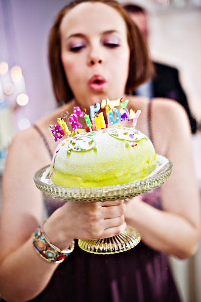 istock Woman blowing out candles 183376896