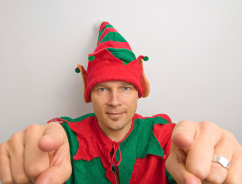 One of Santa's cheeky smiling elves pointing at YOU.