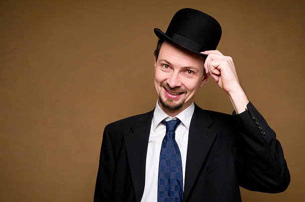 smiling man with hand at his bowler