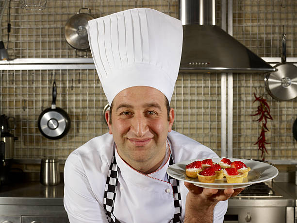 istock Chef Offering Strawberry Tart 183377988