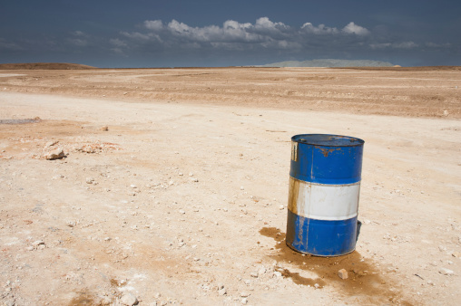 Fuel barrel abandoned in desert. An excellent illustration of environmental pollution.