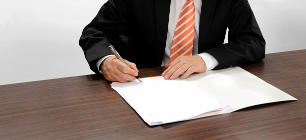 Businessman with magnifying glass analyze contract