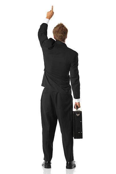 istock Businessman standing with briefcase pointing upwards 183378381