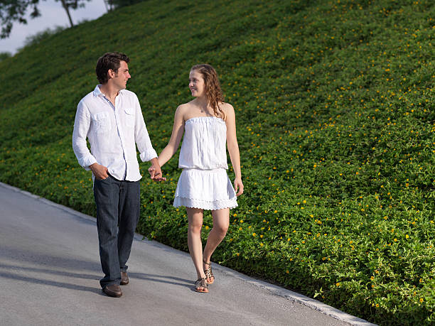 istock Cute couple holding hands and walking 183378532