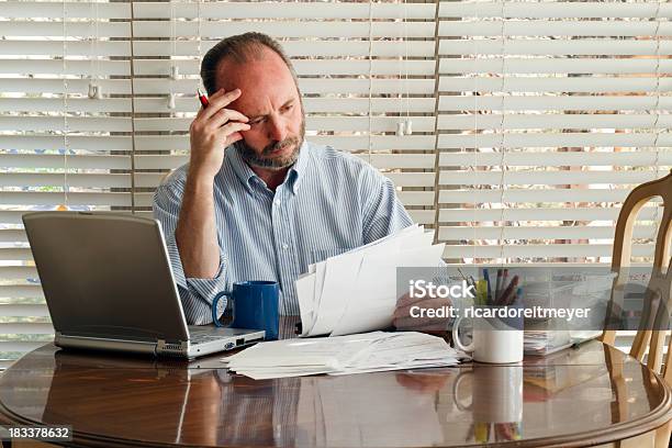 Middle Aged Male Homeowner Struggles With Paying Bills Debt Unemployment Stock Photo - Download Image Now