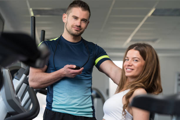 istock Personal Trainer Measure Time On Stopwatch 1833787397