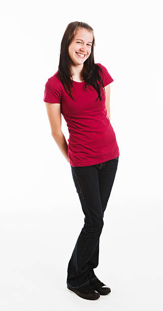 istock Cute teenager standing, full length, hands behind back, smiling 183379250