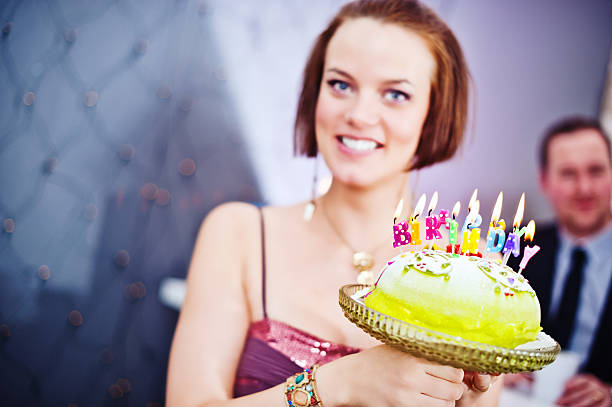 Woman showing a birthday cake