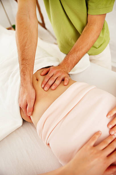 istock Therapist massaging woman's abdomen 183379467