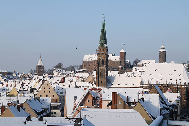Nuremberg St. Sebaldus church with castle sight of nuremberg with Sebaldus Kirche and Kaiserburg in background with snow covered roofs kaiserburg castle stock pictures, royalty-free photos & images