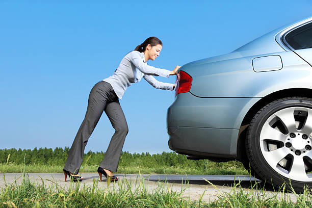 istock Woman is pushing her car. 183380002