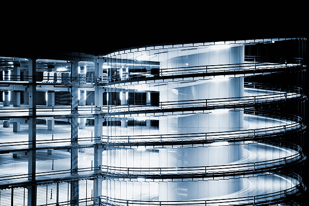 istock Futuristic Spiral Ramp, Multi Storey Car Park Illuminated At Night 183380191