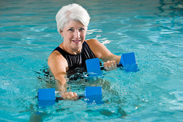 istock Active senior woman doing water aerobics 183380228