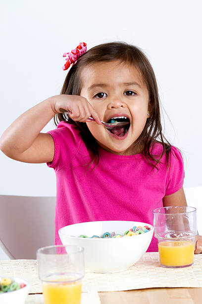 istock Little Girl Eating Breakfast Cereal 183380399